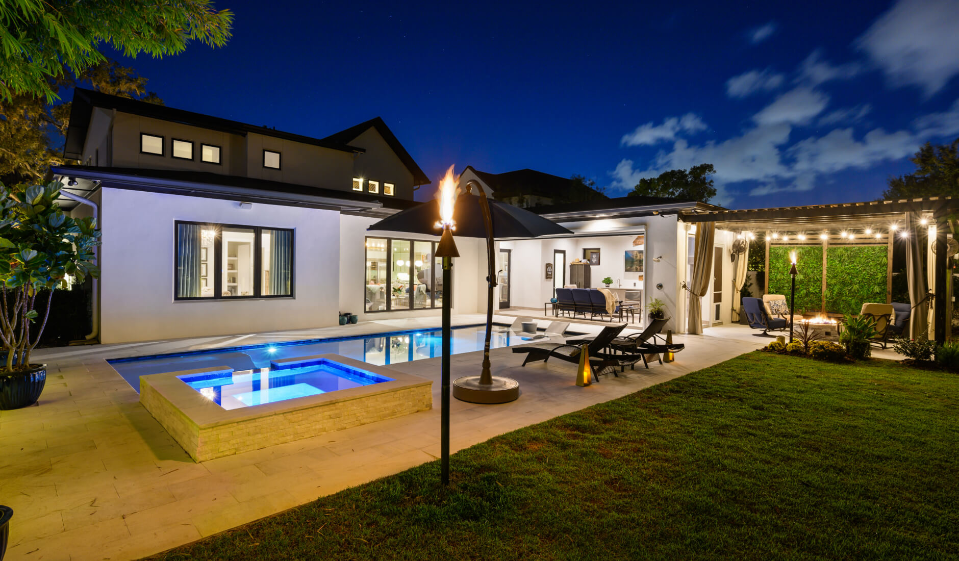 House with background deck and patio lighting