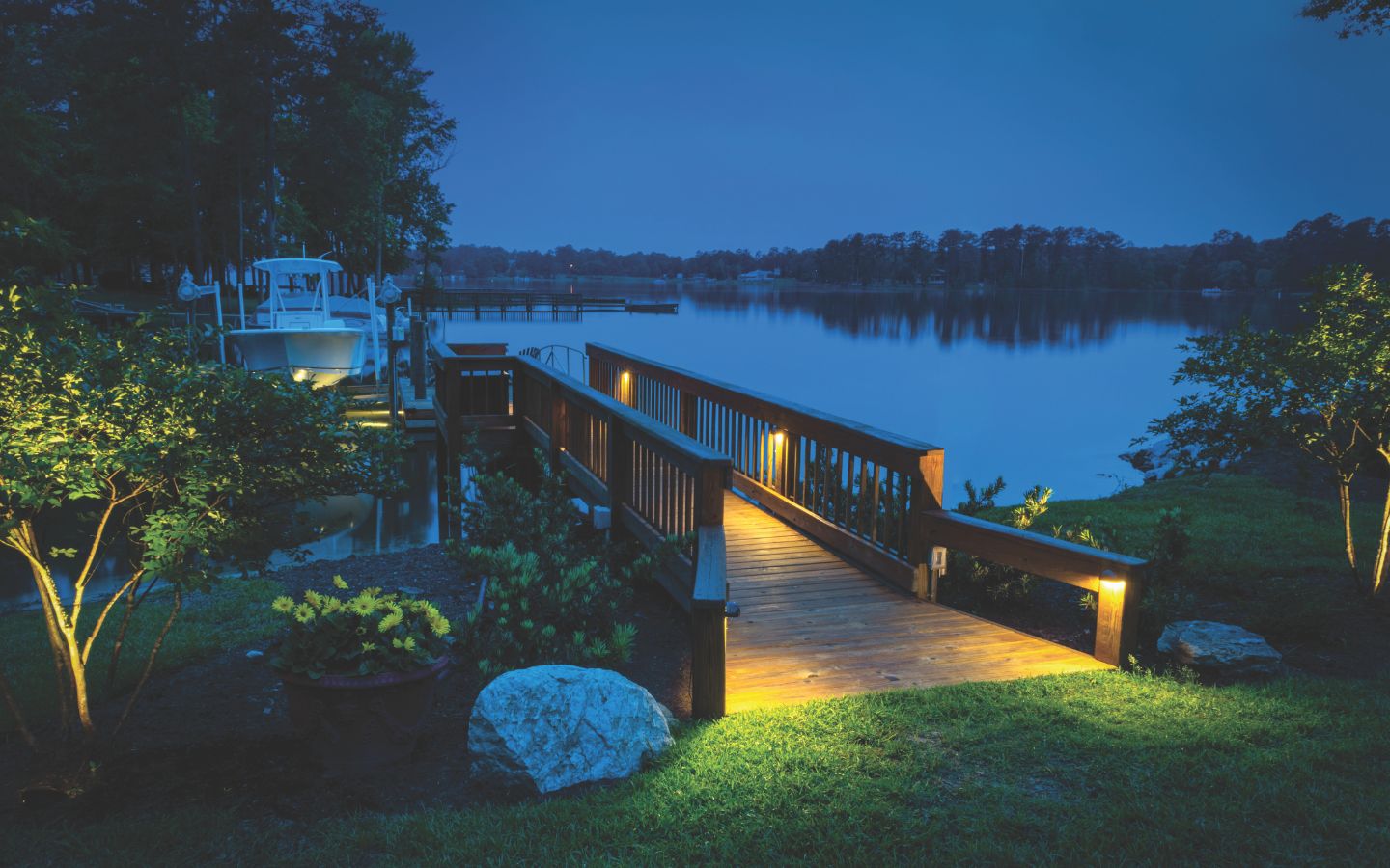 A deck with lights on the side of the dock

Description automatically generated