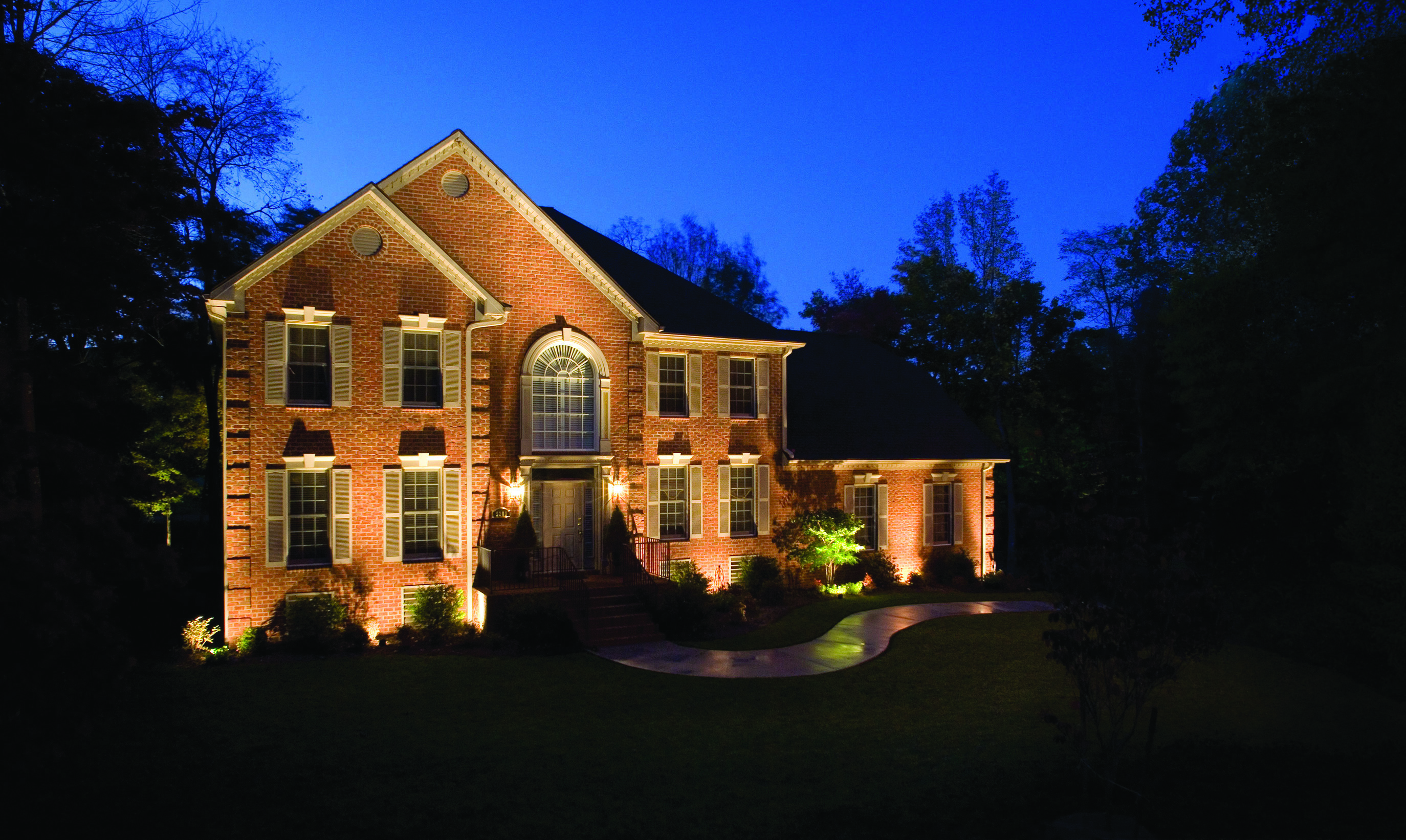 front of home lit up with outdoor lighting
