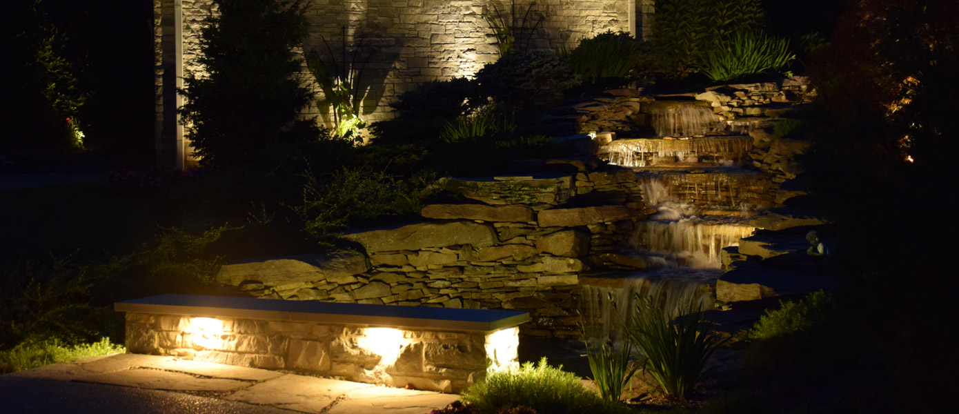 under stair/path lighting and architectural lighting on a stone house  