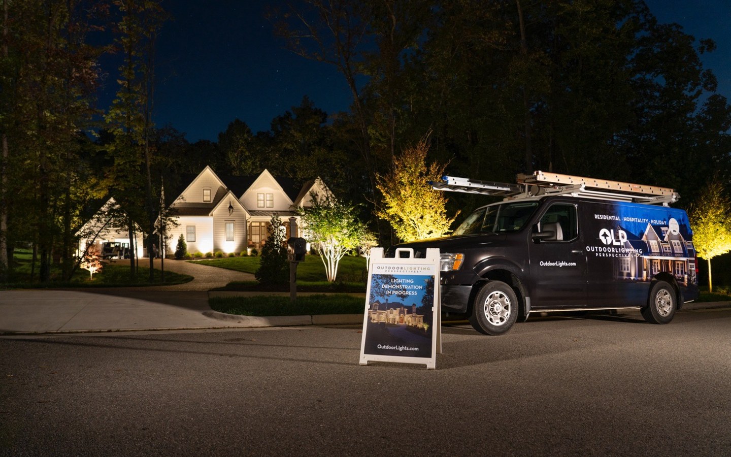 A black van parked in front of a house

Description automatically generated