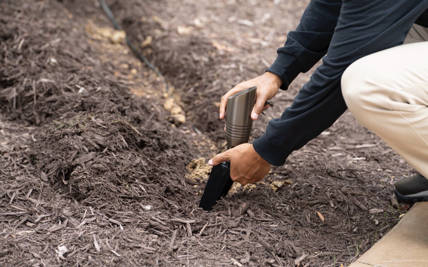 A person digging in the ground

Description automatically generated