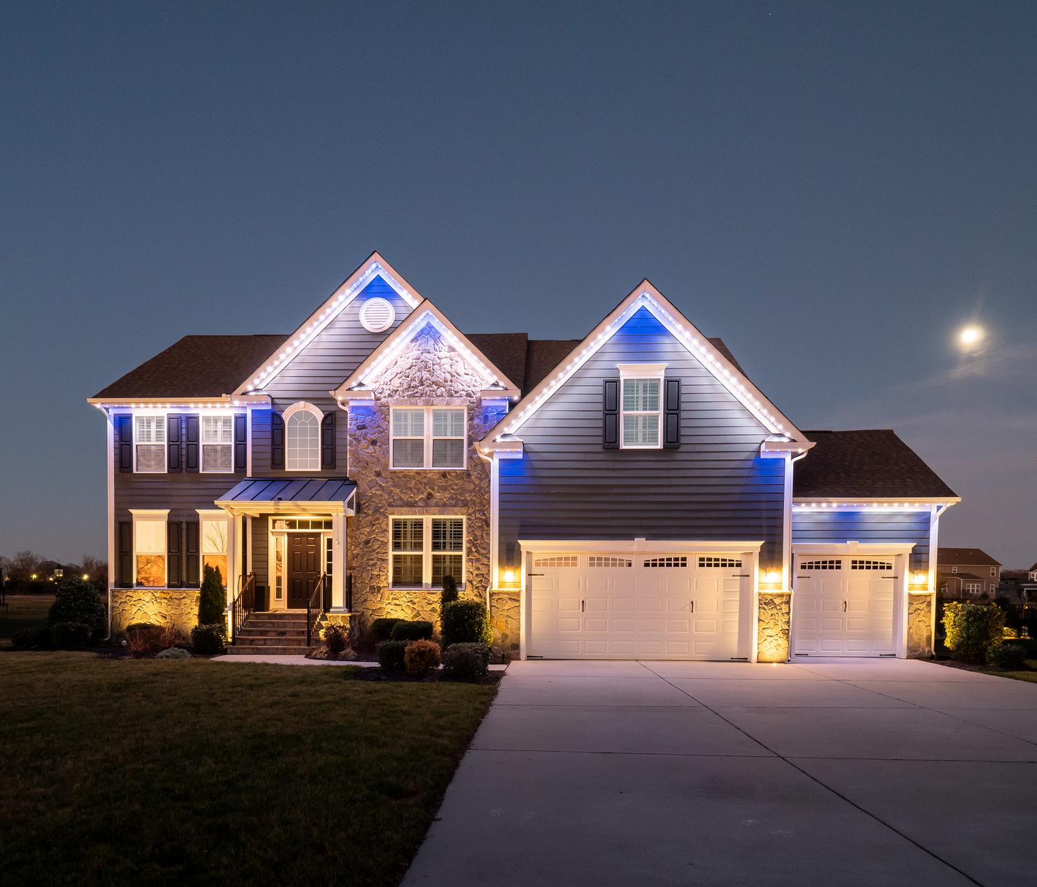 stone house with blue exterior lighting