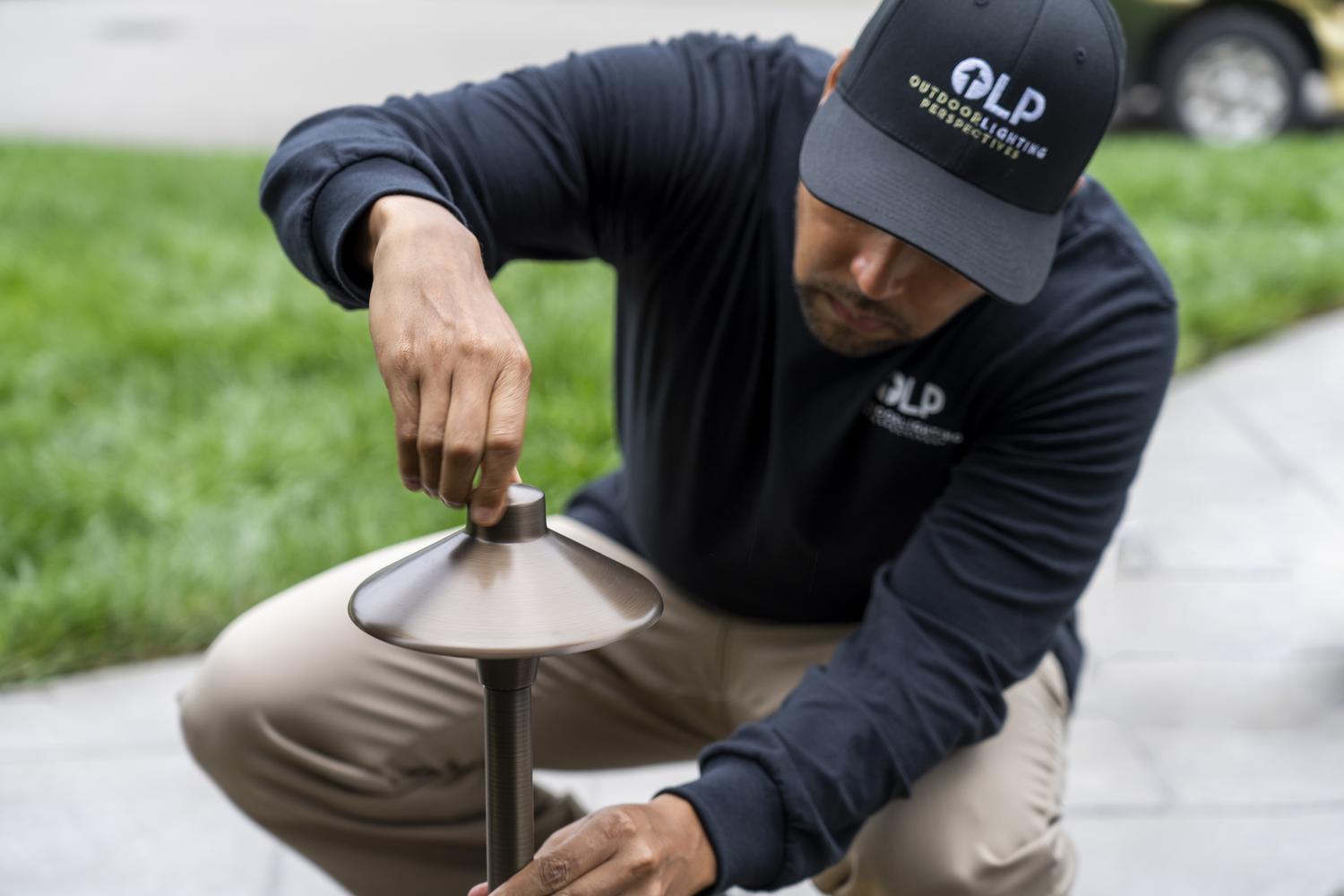 OLP worker fixing lawn light