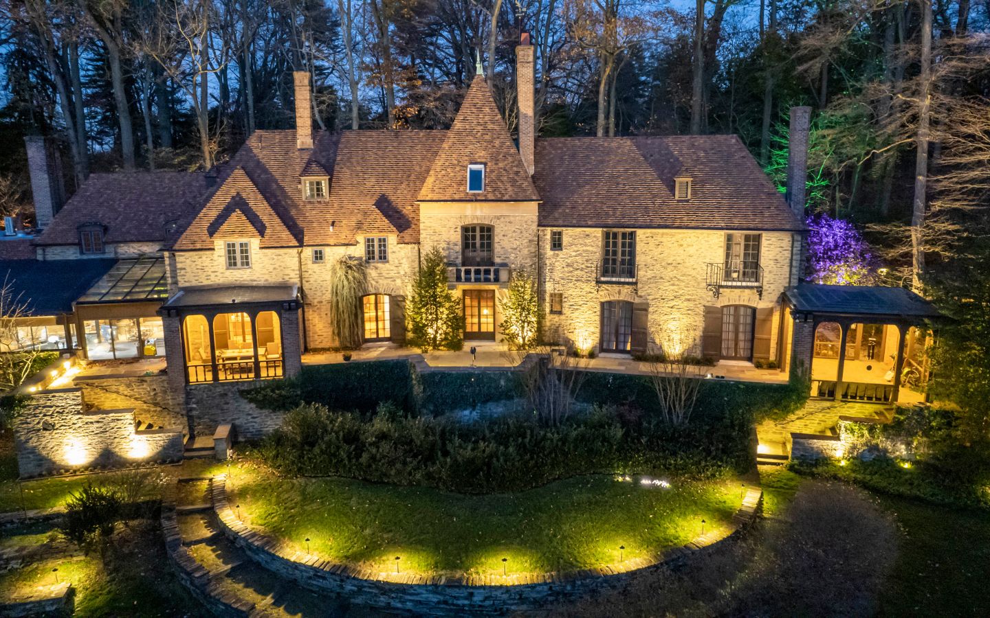 aerial view of home with outdoor lighting