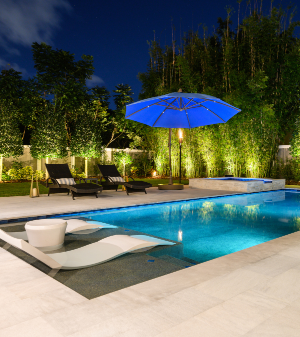 outdoor pool with umbrella in evening