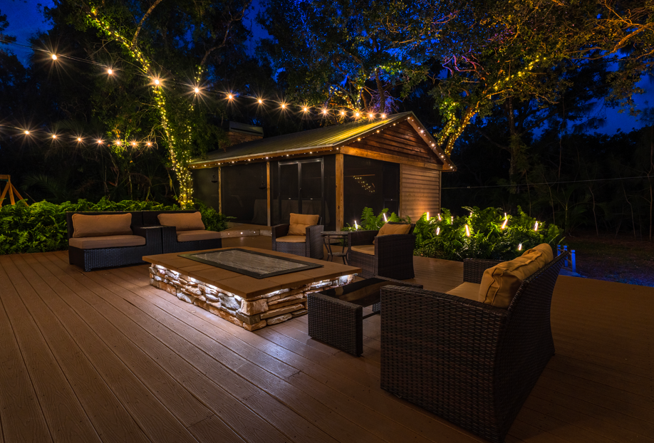 backyard illuminated with outdoor lighting