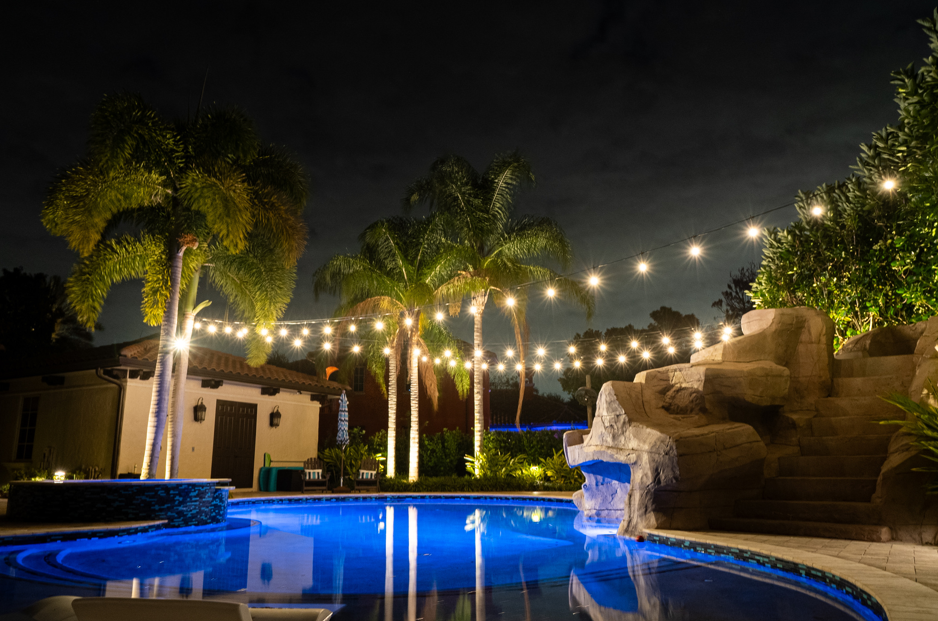 backyard illuminated with outdoor lighting