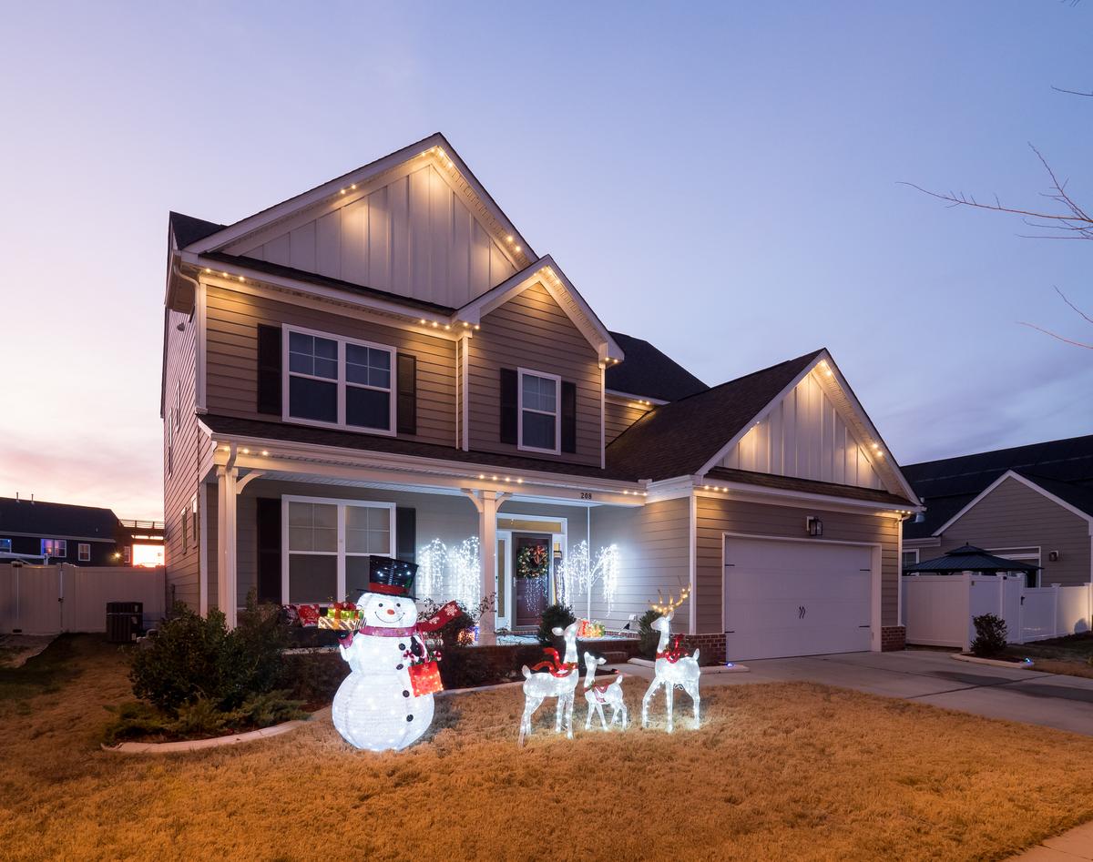 Light snow man in front yard