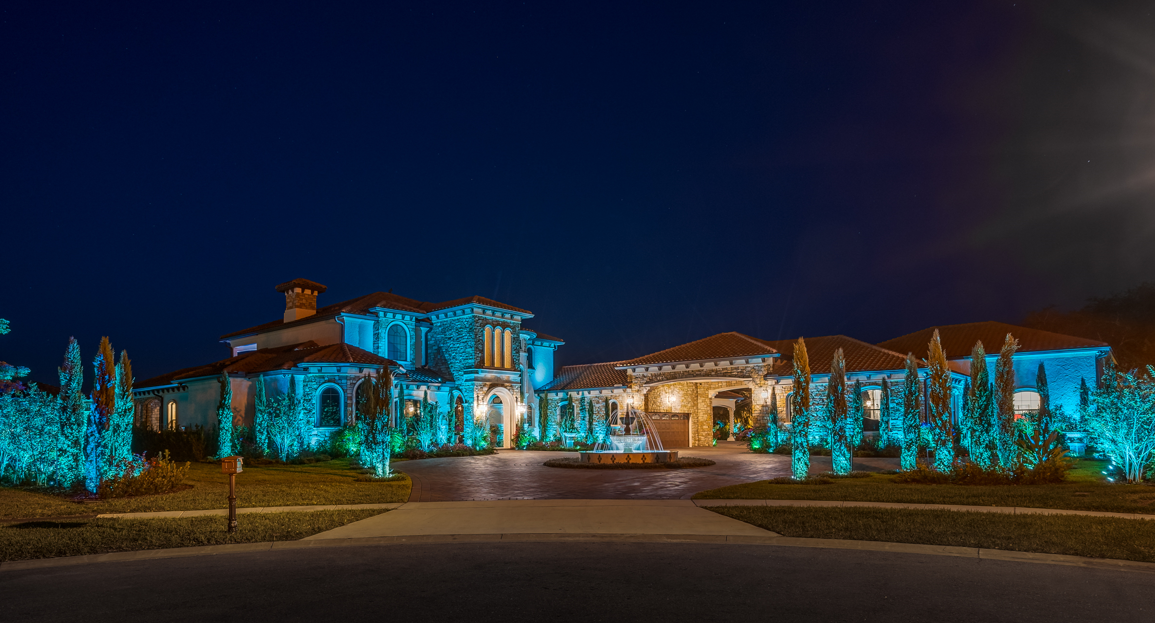 front yard illuminated with outdoor lighting