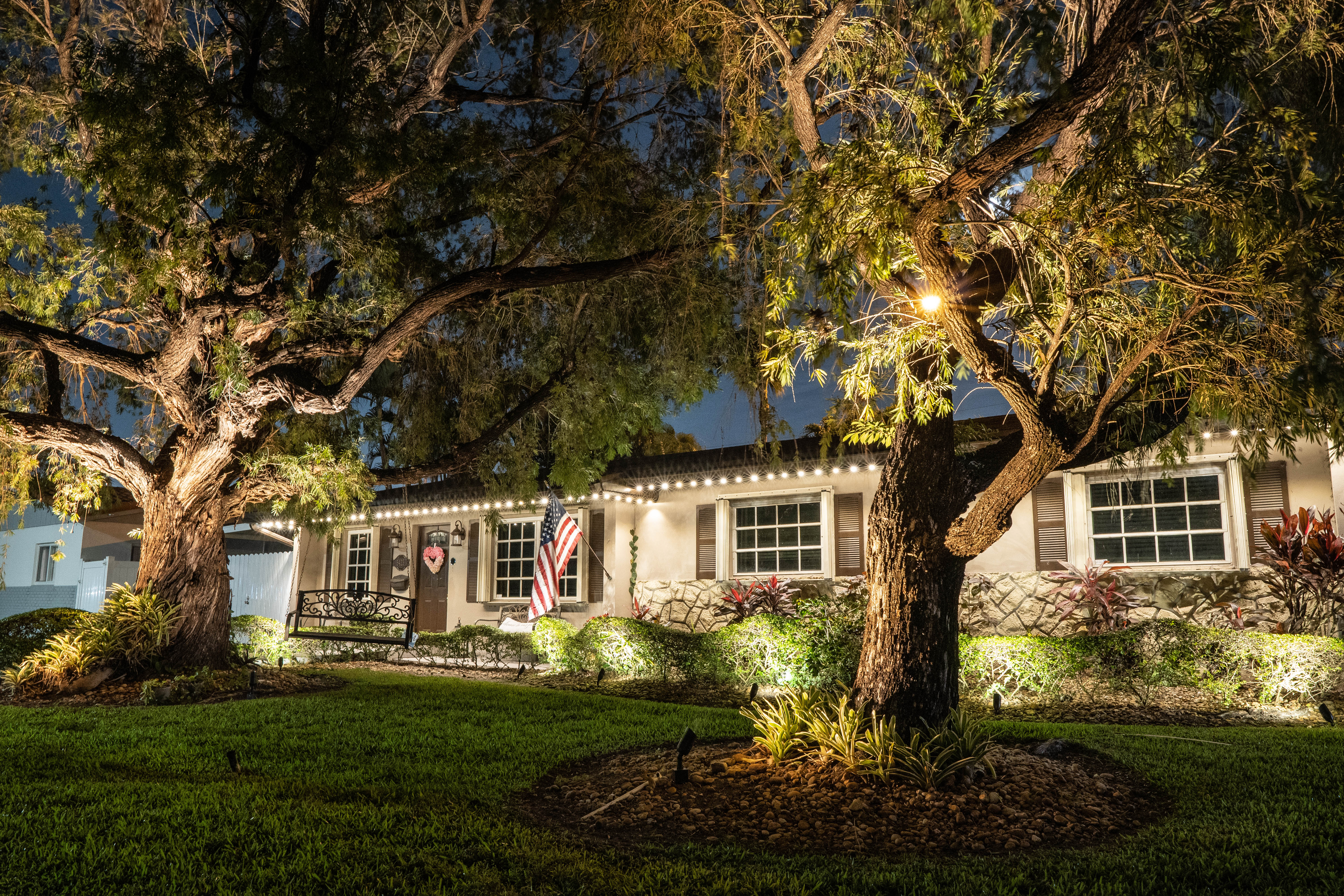 Outdoor lighting highlighting garden features and exterior of Miami home.