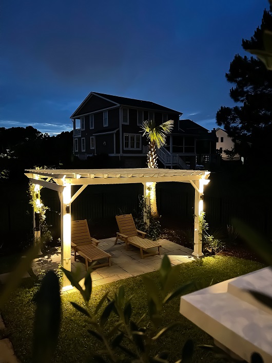 backyard with lawn chairs and lighting